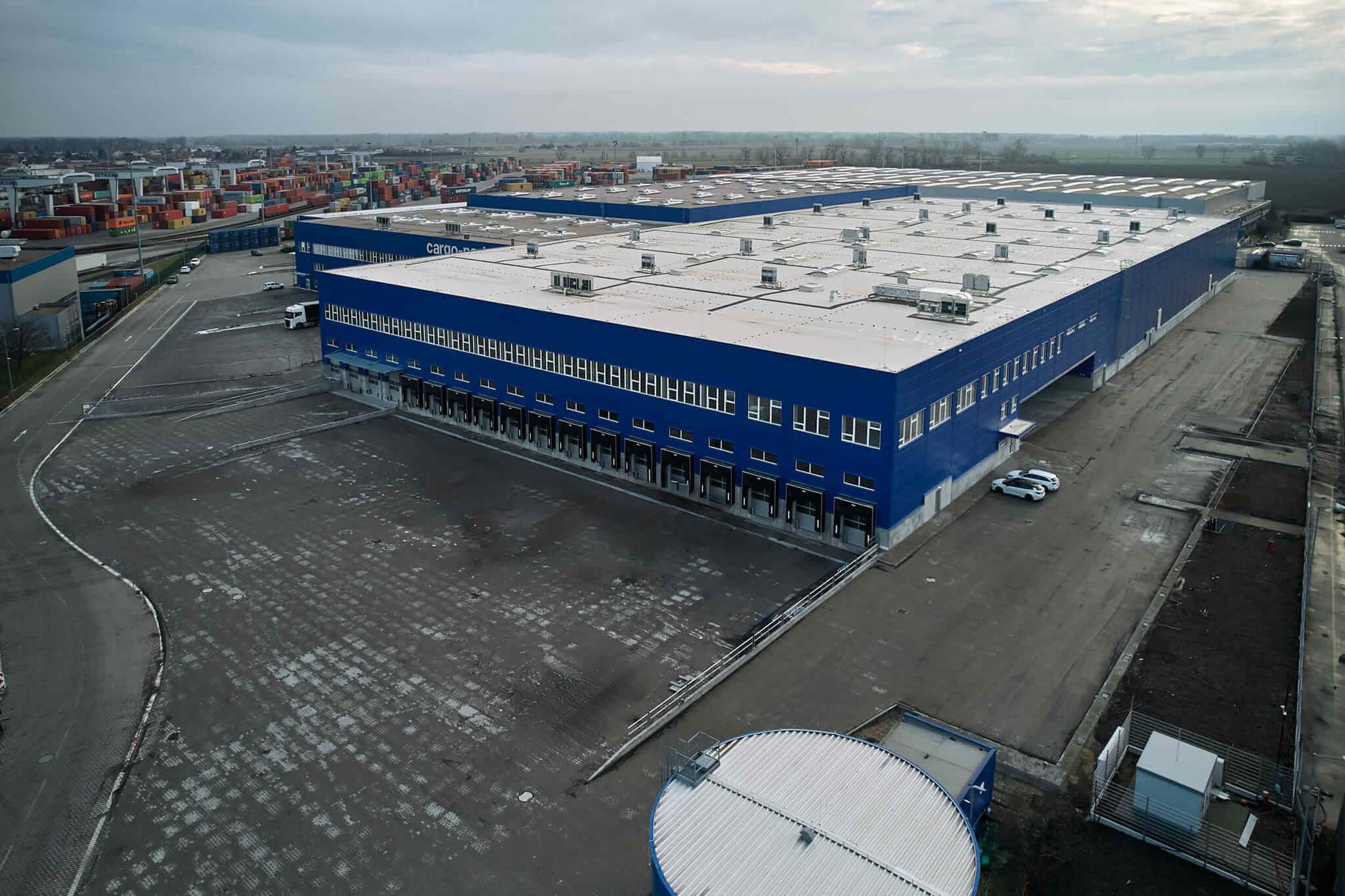 Aerial view of a large blue commercial complex with warehouses